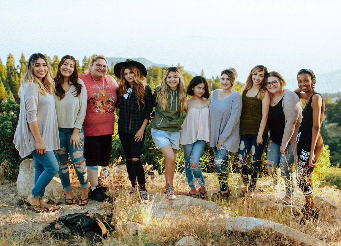 Group of smiling people at an outdoor retreat.